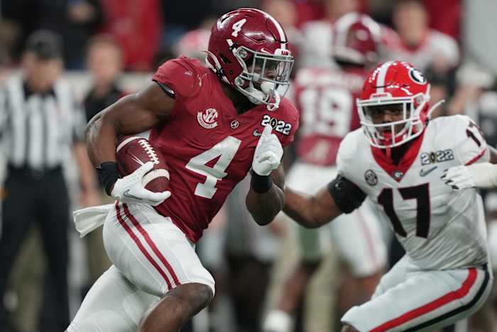 Alabama Crimson Tide running back Brian Robinson Jr. (4) runs the ball against Georgia Bulldogs linebacker Nakobe Dean (17) during the second quarter of the 2022 CFP college football national championship game at Lucas Oil Stadium.